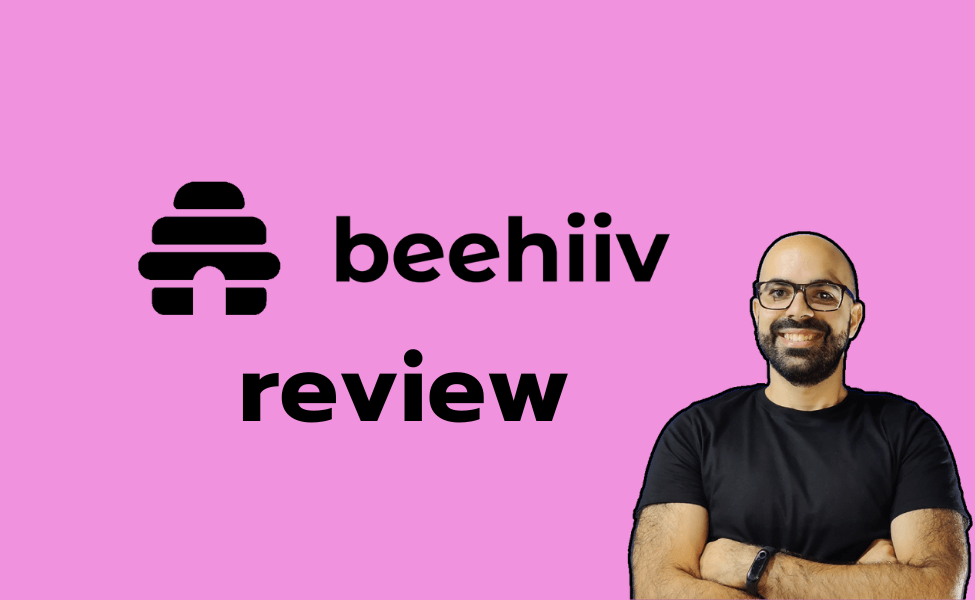 The beehiiv logo and the word "review", and Tiago smiling with arms crossed on the right, in a bright pink background.