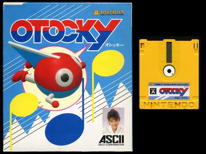 A photo shows Otocky's packaging art, with the game's main character on a blue background, alongside a copy of the Famicom Disk System game.