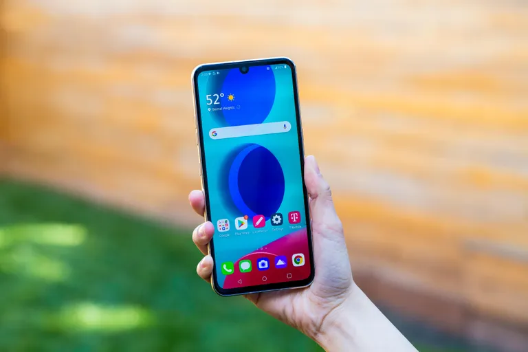 A hand holding the LG V60.