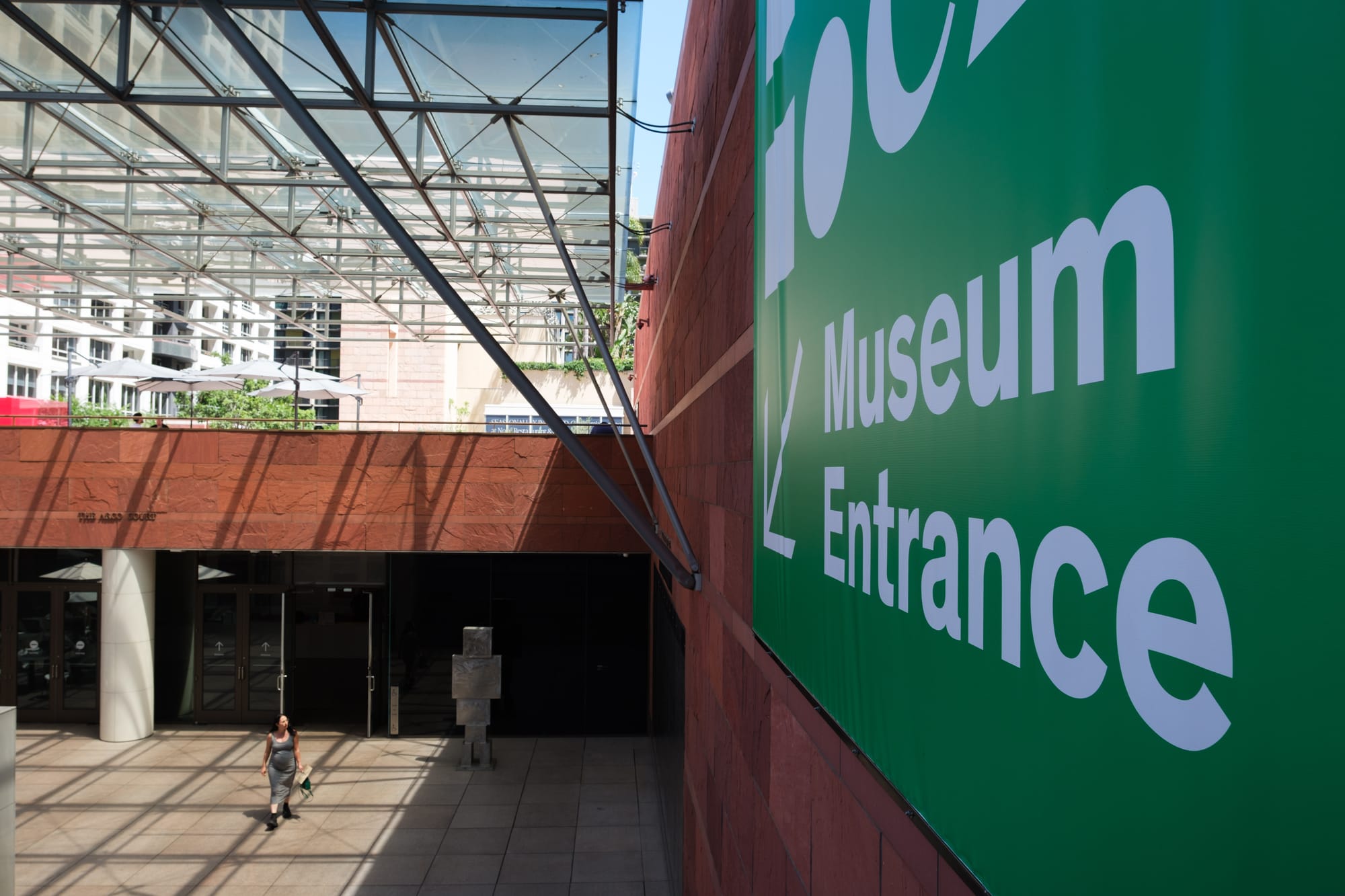 The entrance to MOCA. A museum attendee walks out of the doors. Credit: Ben Camacho