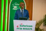 Safaricom CEO Peter Ndegwa speaking at a podium during the Safaricom FY26 Results presentation against a green-and-white branded backdrop.