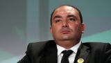 Close-up portrait of Moncef Belkhayat, Chairman and CEO of Dislog Group, wearing a dark suit and white shirt.