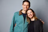 Studio portrait of Healthleap co-founders and South African siblings Josiah Meyer and Jemima Meyer smiling together against a light gray studio background.
