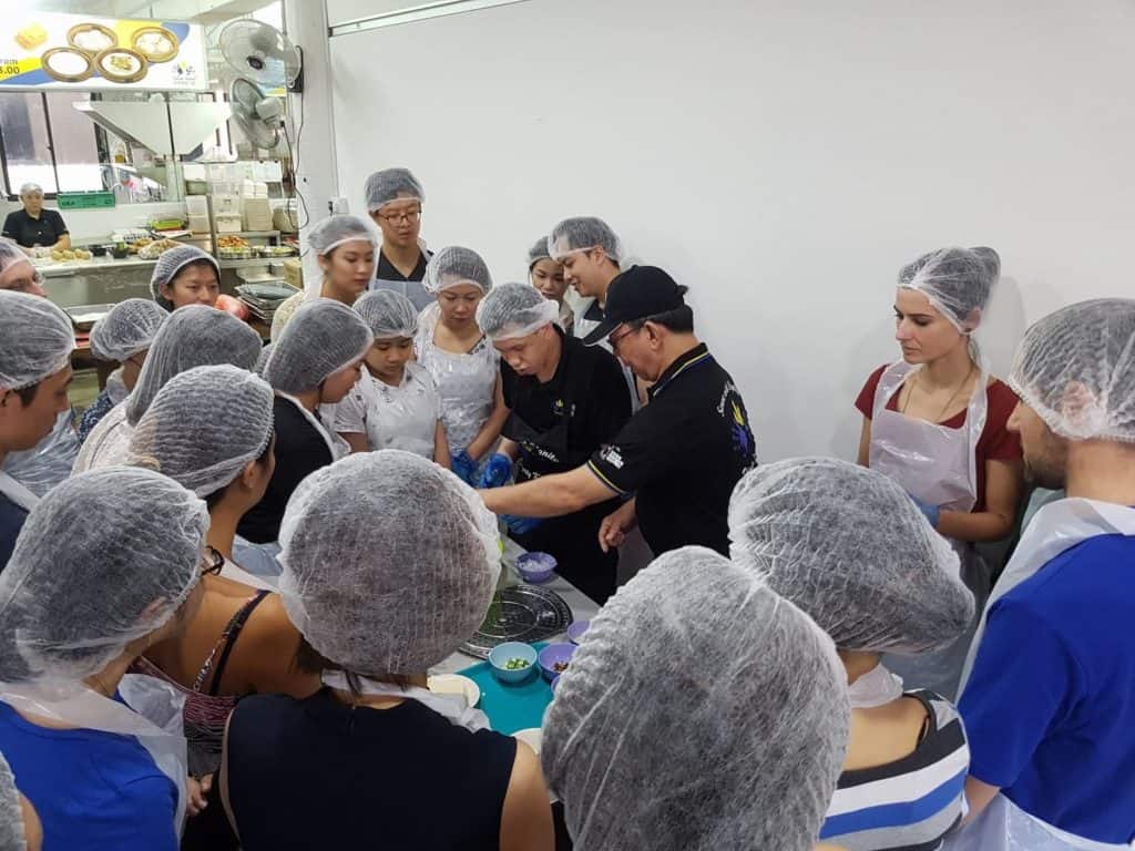 Special needs trainer teaching the craft of ondeh ondeh