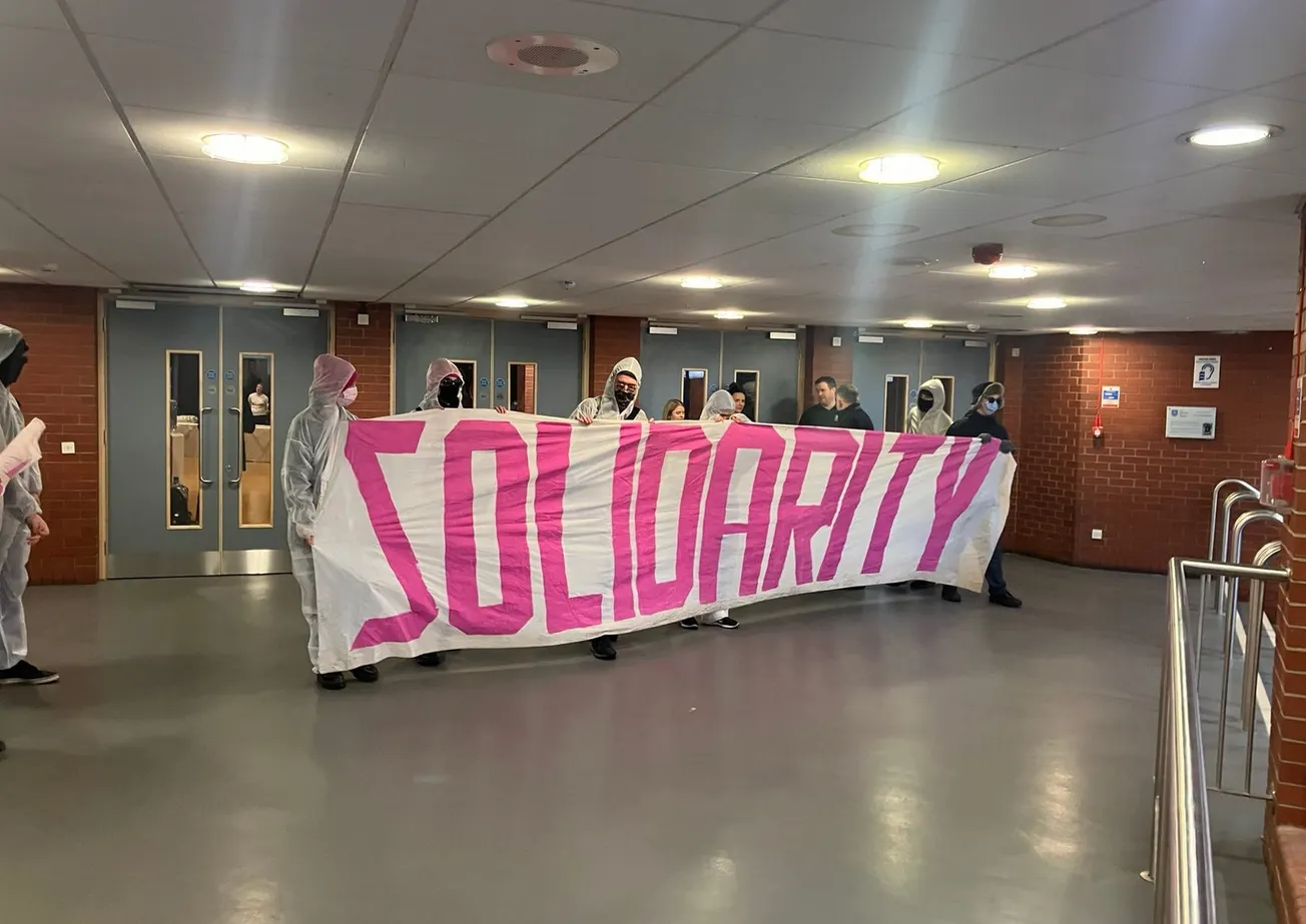 Two university students held up a banner - now they’re banned from campus