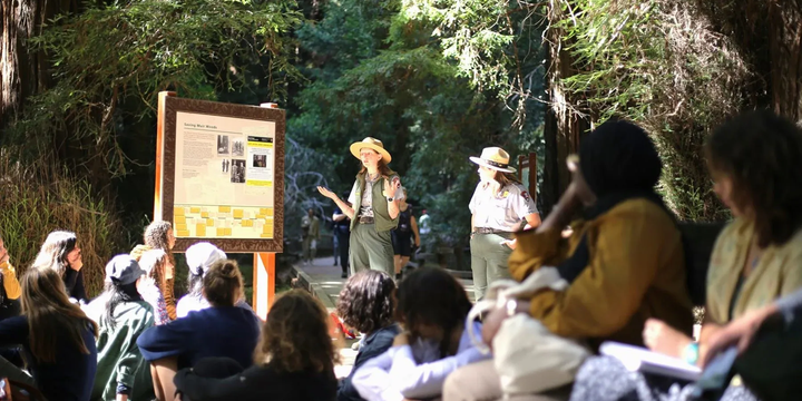 Muir Woods rangers discuss different historical narratives with a student group. 