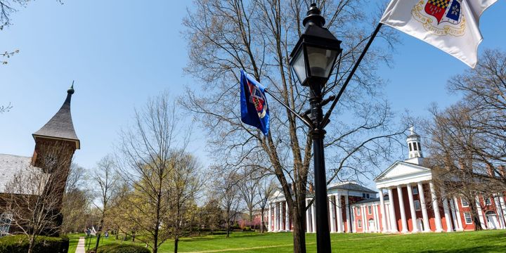 Washington and Lee University hall buildings in Virginia exterior facade during sunny day with nobody, exterior brick architecture, flags.