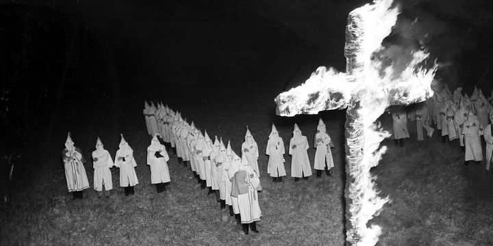 The Ku Klux Klan and a burning cross.