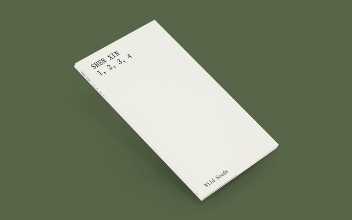 a digital render of the physical book standing against a green background, the book has a white and plain cover, that reads Shen Xin, 1, 2, 3, 4, Wild Seeds