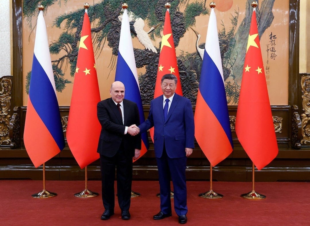 China, Russia vow joint response to 'unilateral' sanctions during Russian PM  visit | Reuters
