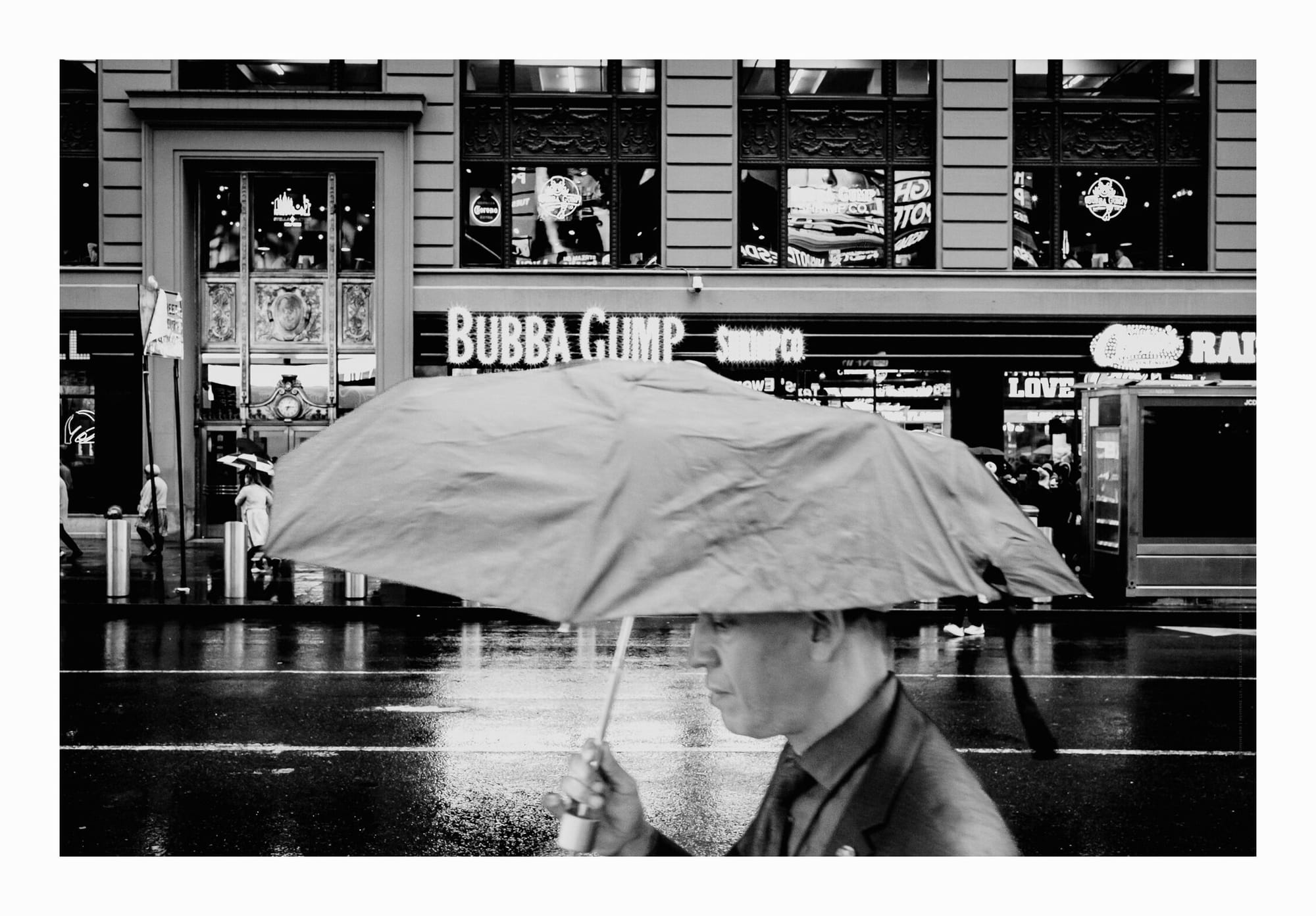 Pansative, Passerby, Manhattan, Times Square, Bubba Gump, Rain, Black and White Fine Art Photo.