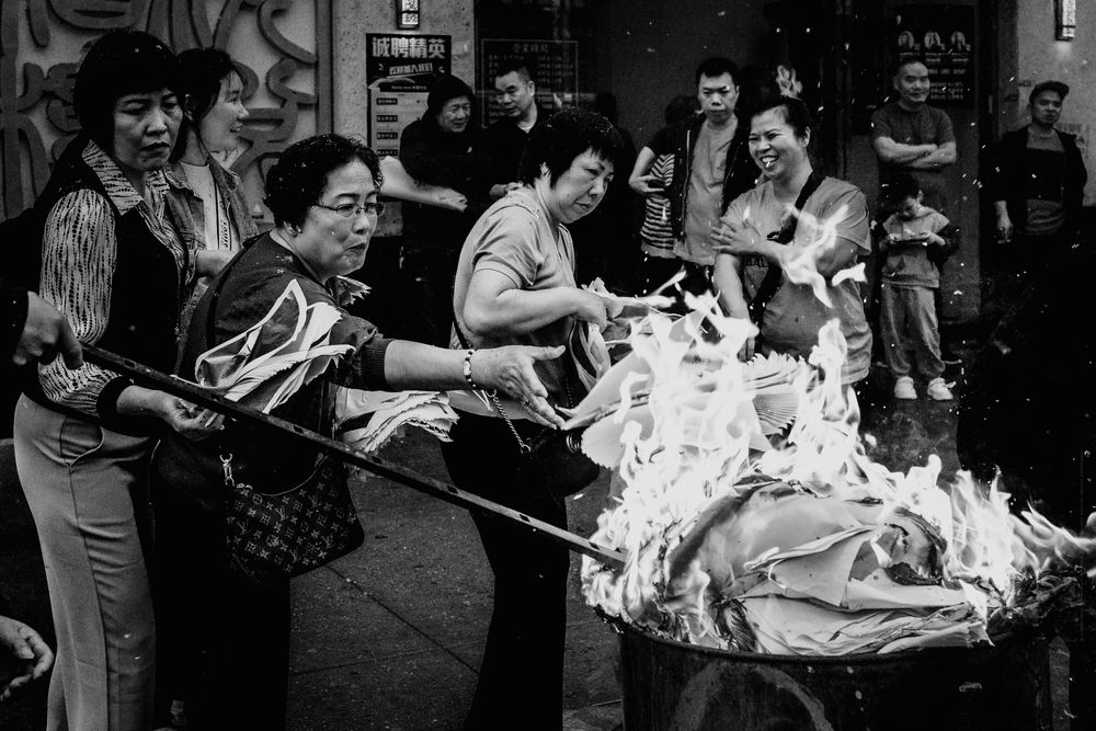 People burning paper, metal barrel, crowd, Brooklyn, Chinatown, black and white fine art photo.