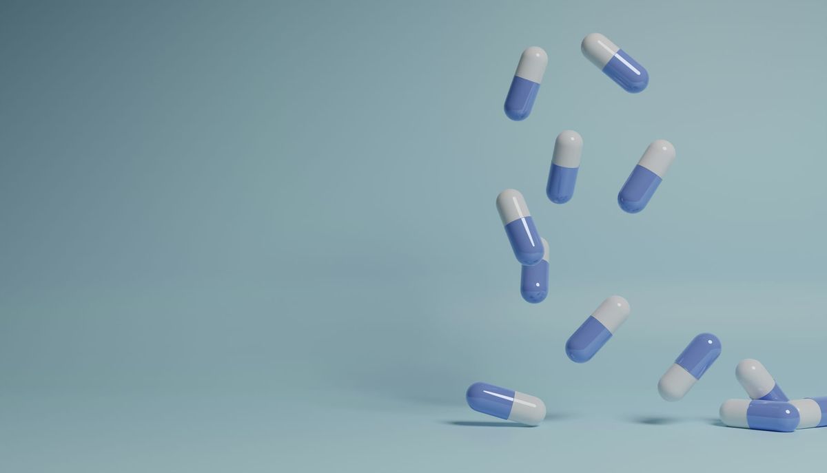 Pharmaceutical capsules falling from the air onto a surface