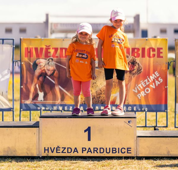 Two kids on the victory podium
