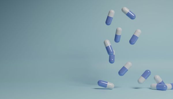 Pharmaceutical capsules falling from the air onto a surface