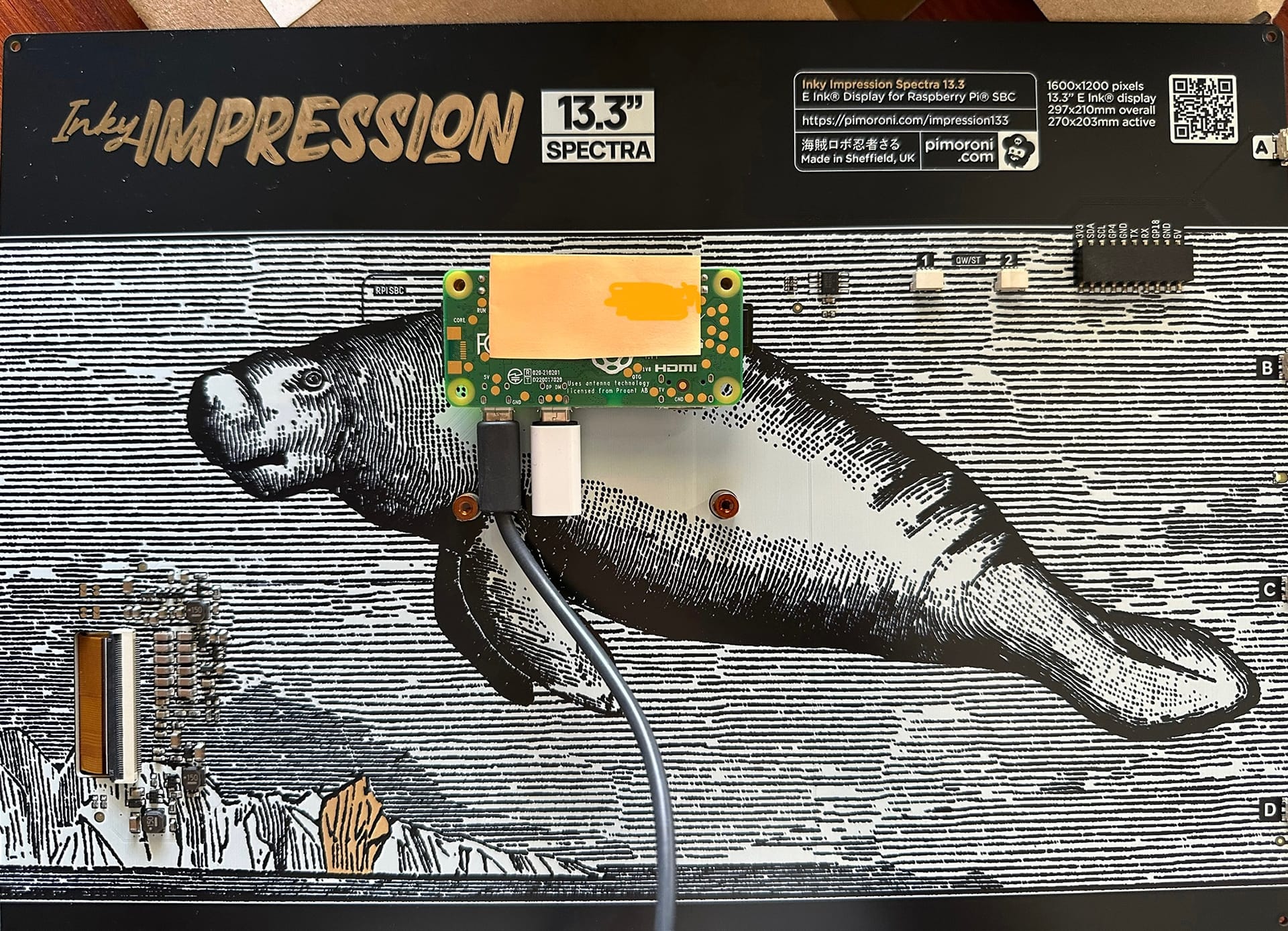 A 13.3-inch Inky Impression board dwarfs a Raspberry Pi Zero 2 W