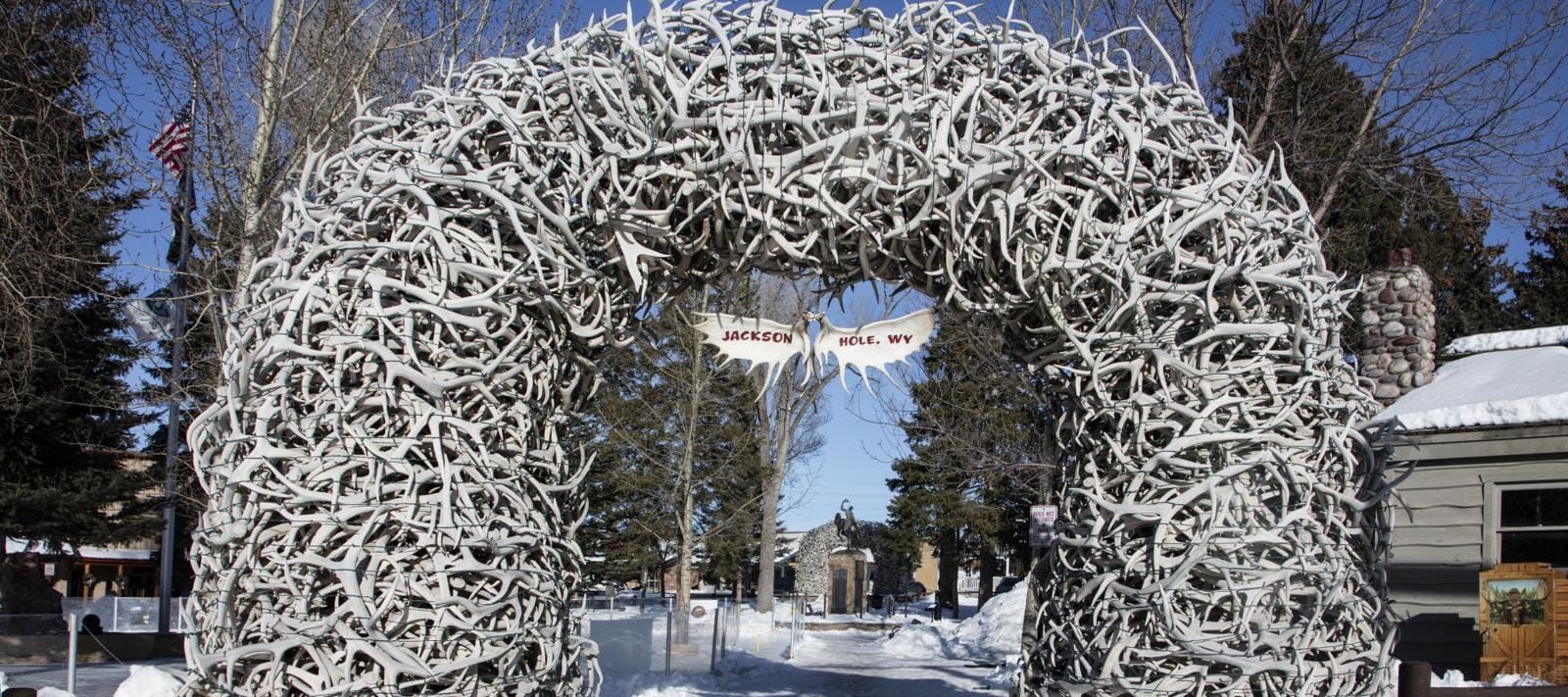 An elk antler arch on the Jackson, Wyoming town square in winter, with snow on the ground