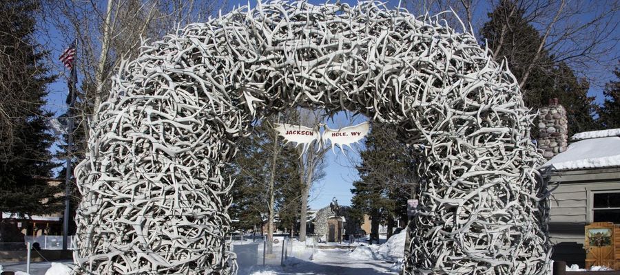 An elk antler arch on the Jackson, Wyoming town square in winter, with snow on the ground