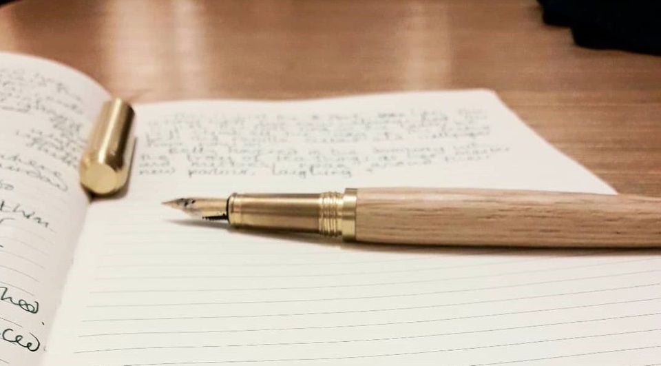 A fountain pen on a book.