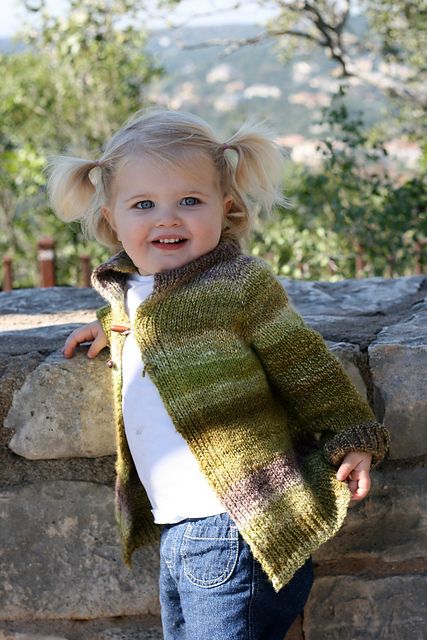 Marlowe smiling in her handspun, handknit cardigan, made by Christina
