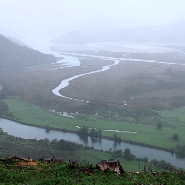 View from the land to the estuary with clouds and rain