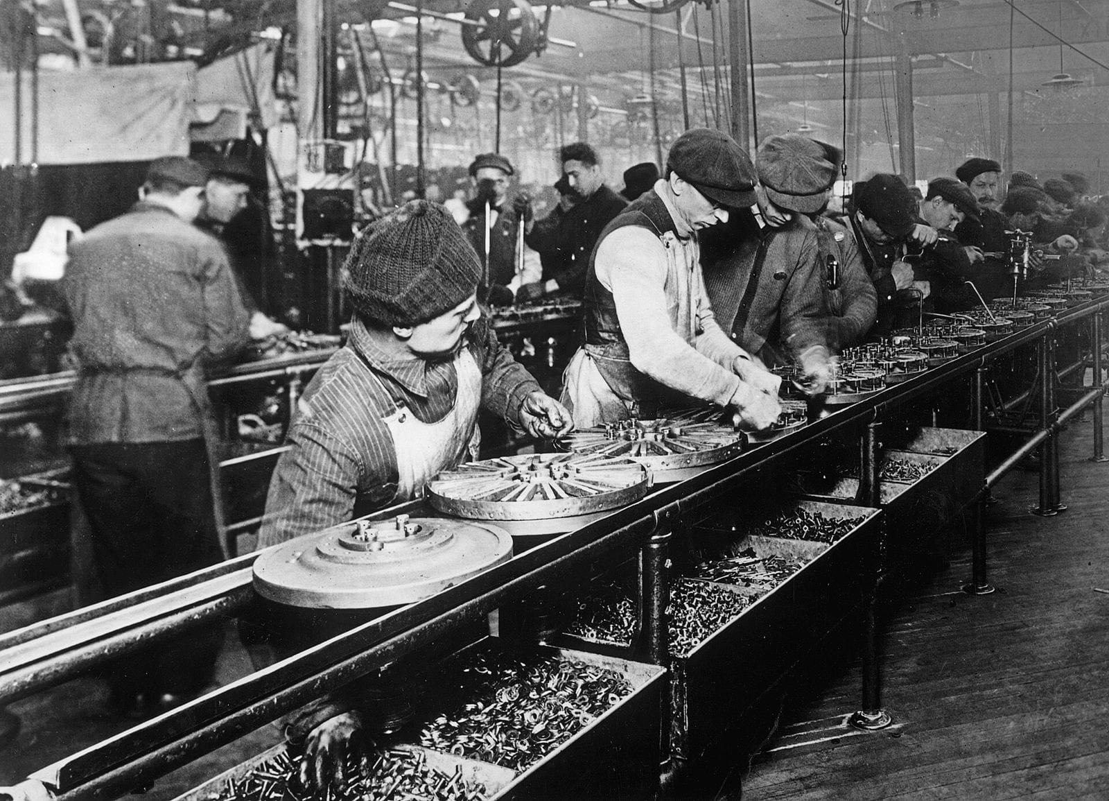 Workers on an early assembly line