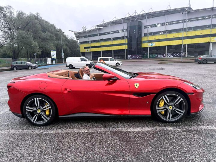 Red Ferrari Portofino M with the top down