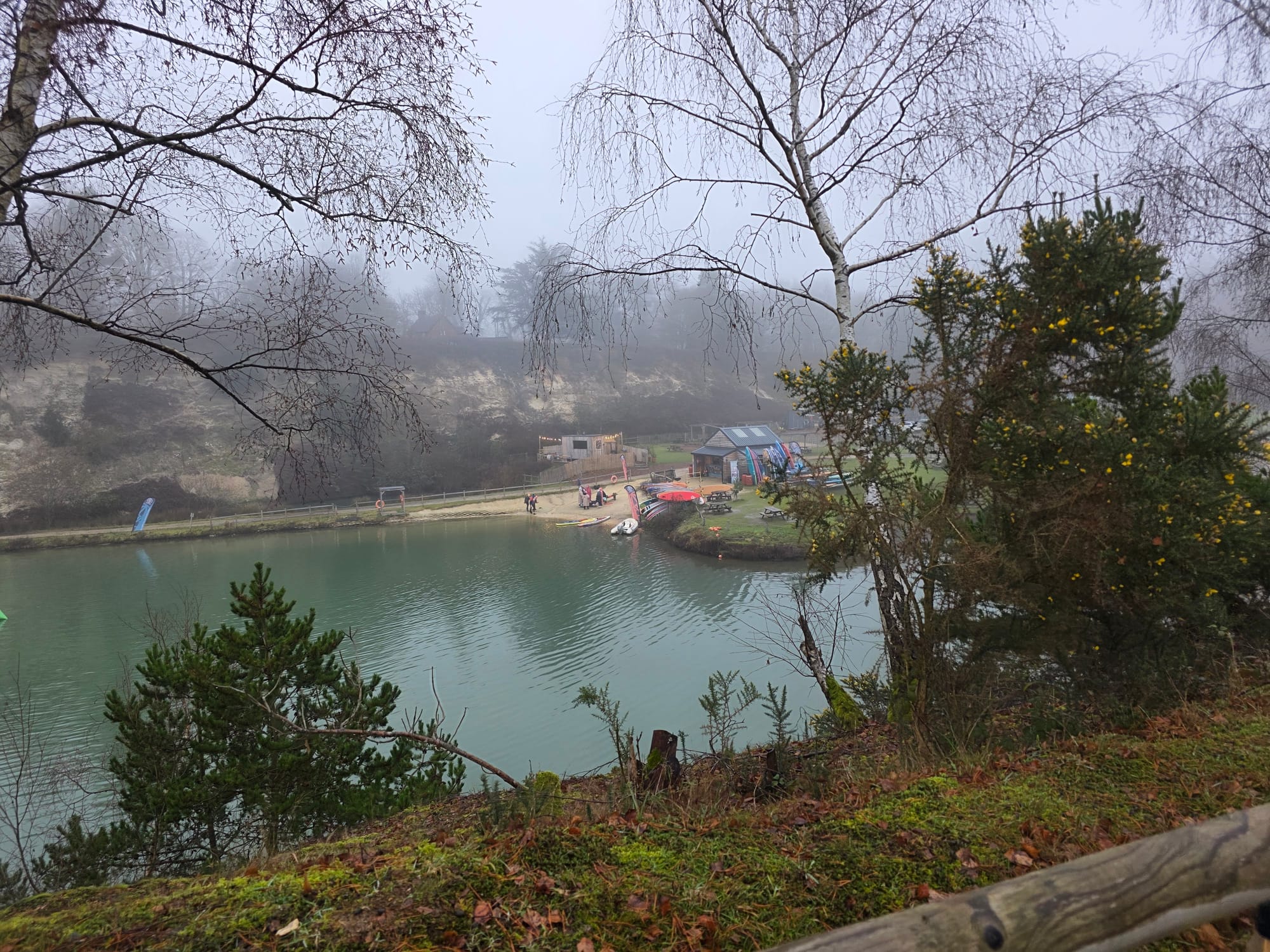 Misty view over Buckland Park Lake with the Savu sauna site visible across the water.