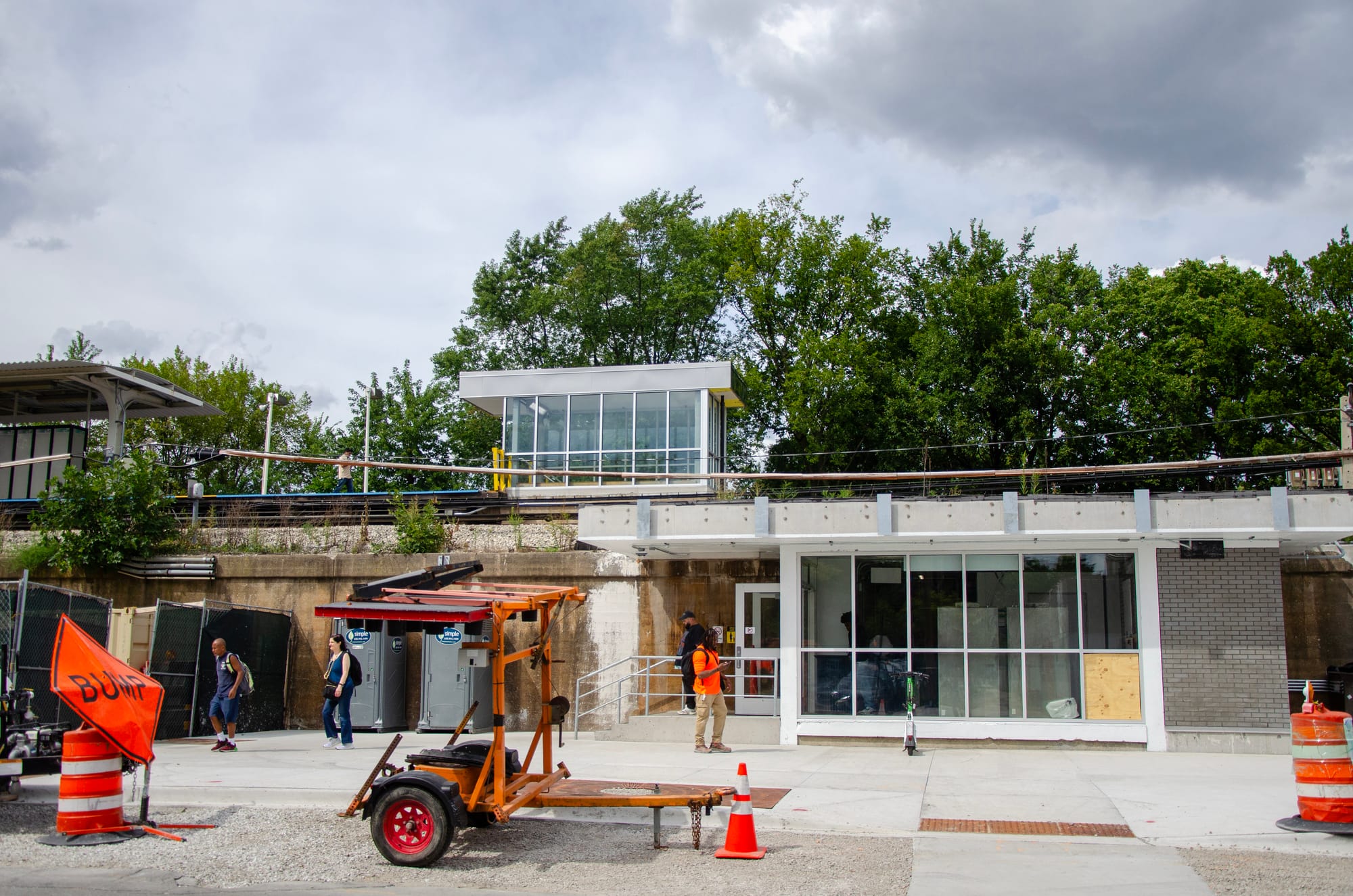 A variety of riders are shown exiting the Austin station through a temporary entrance located at Corcoran Place and Mason Avenue. 