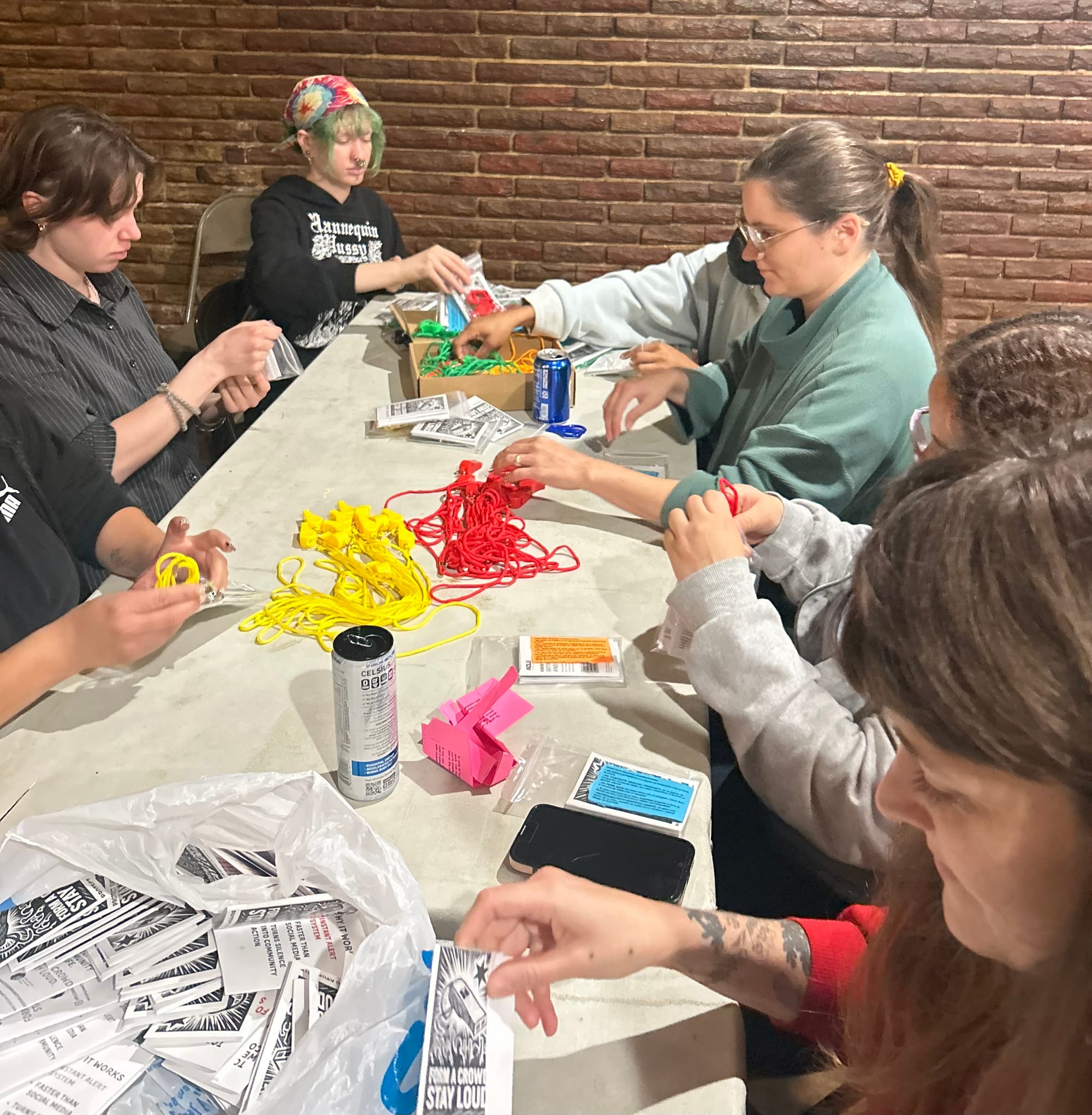 Volunteers assemble whistle kits at Pizzeria Martello's in Hermosa | Lauren Neher/15 West
