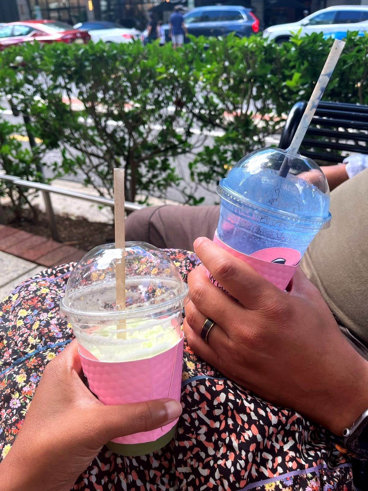 My husband and I holding our smoothies side by side, with my handmade skirt visible in the background.