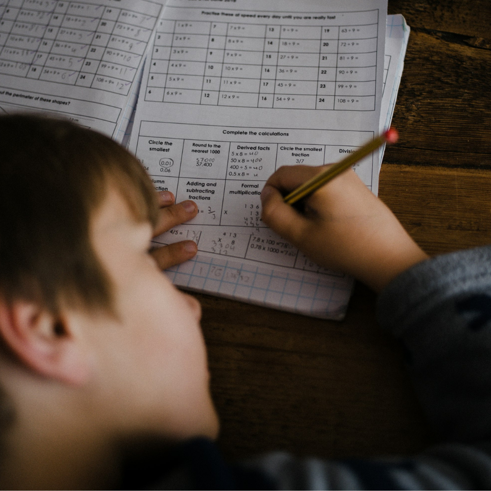A child working on a math spreadsheet
