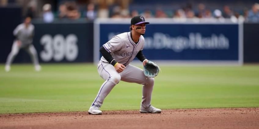 Tovar crouches, waiting for the play to begin. His glove is a faded blue.