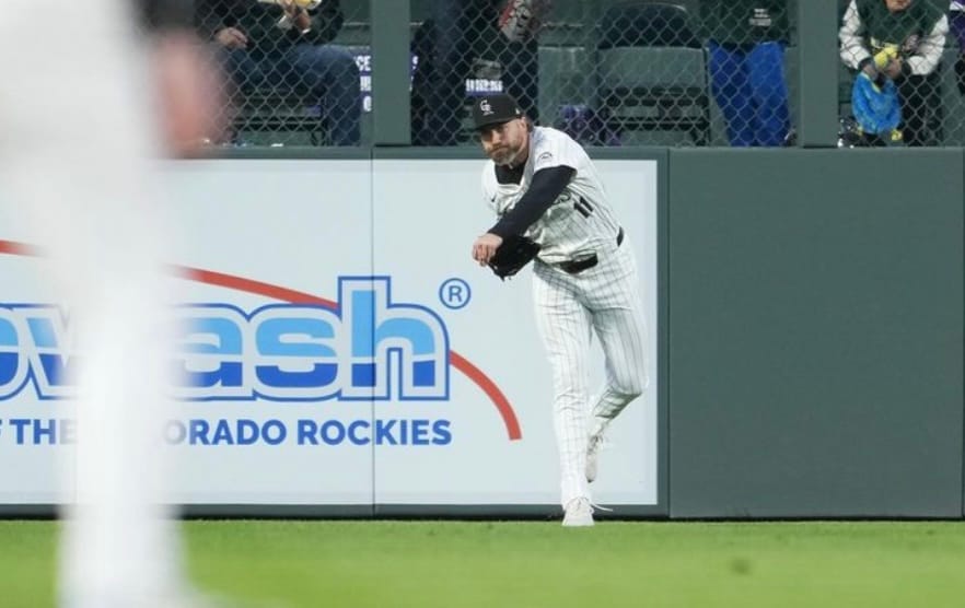 Cave is wearing purple pinstripes as he throws the ball in.