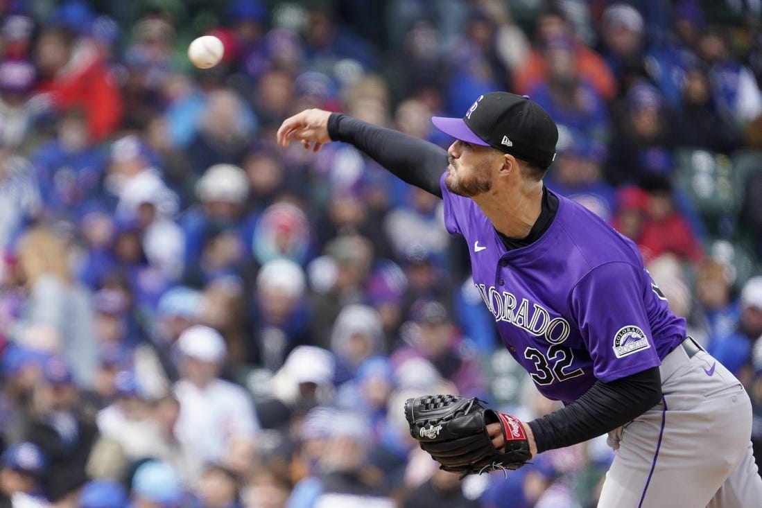 Hudson just releases the ball when pitching. He’s wearing a purple jersey and gray pants.