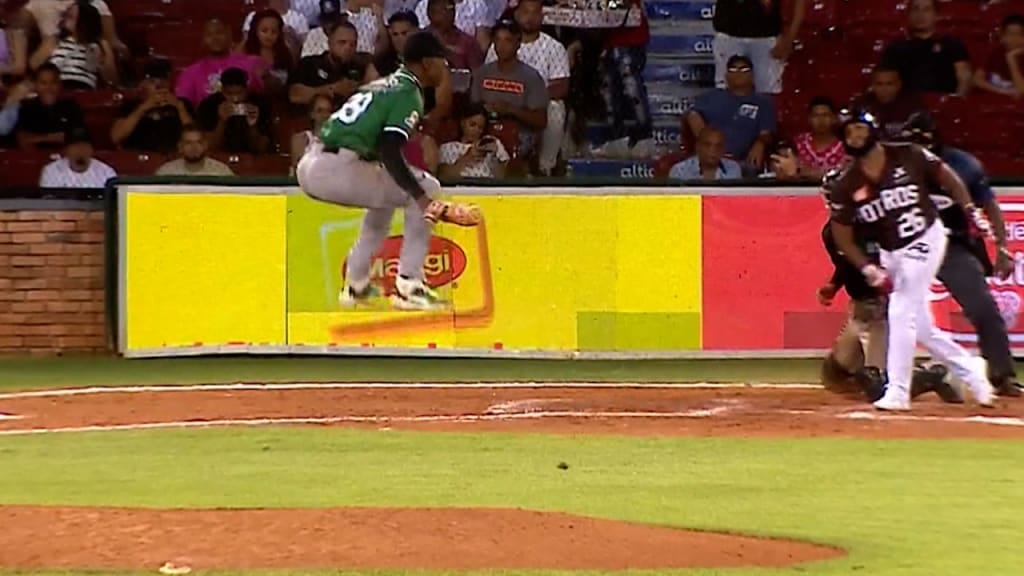 Wearing a green jersey, Yan leaps into the air after scoring another K.
