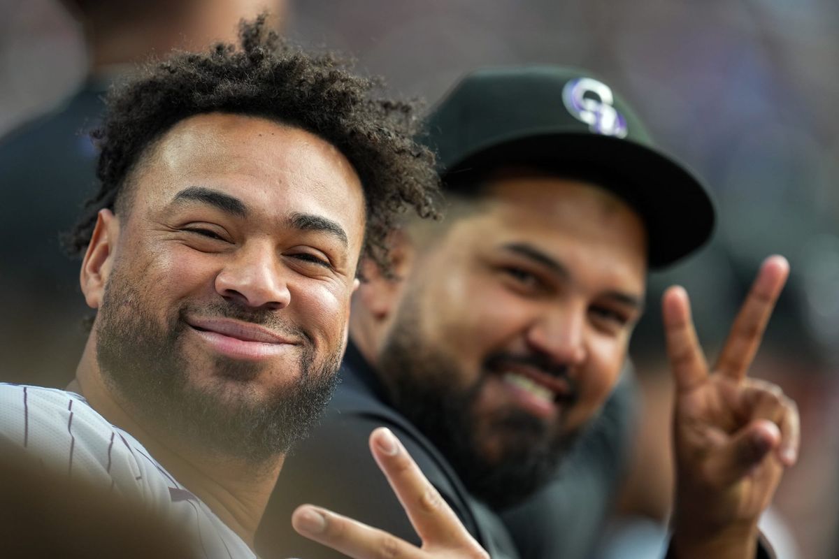 Díaz and Márquez smile at the camera from the dugout. They are clearly having fun!