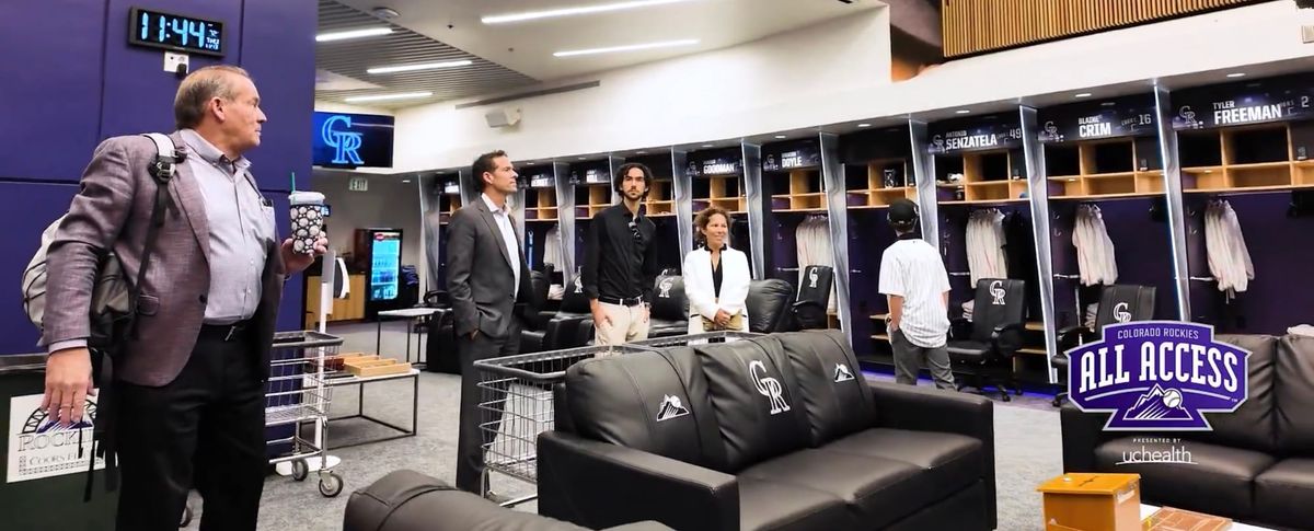 Paul DePodesta and his family (and Dick Monfort) tour the Rockies’ clubhouse.