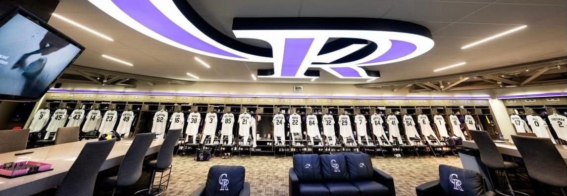 A shot of the Rockies clubhouse. Jerseys line the lockers, and there’s a huge CR on the ceiling.