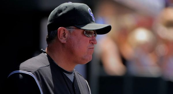 A photo of a younger Clint Hurdle wearing a black vest and Rockies cap.