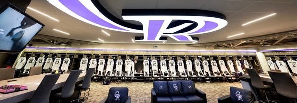 A shot of the Rockies clubhouse. Jerseys line the lockers, and there’s a huge CR on the ceiling.