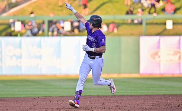 Cole Carrigg points to the sky while rounding the bases.