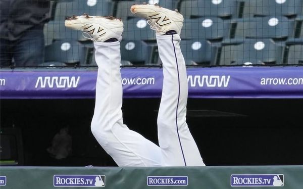 The legs of TJ Rumfield has a makes a diving catch into the dugout.
