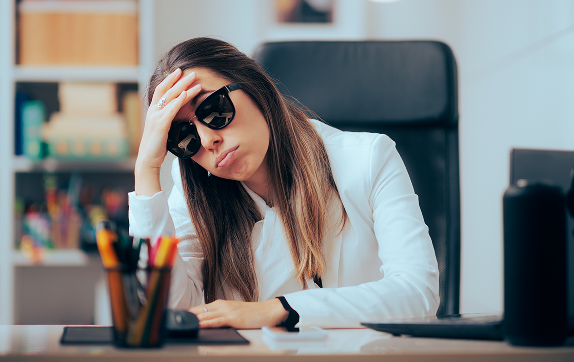 A woman with low energy and a headache, in need of a hangover iv therapy drip in Richmond TX