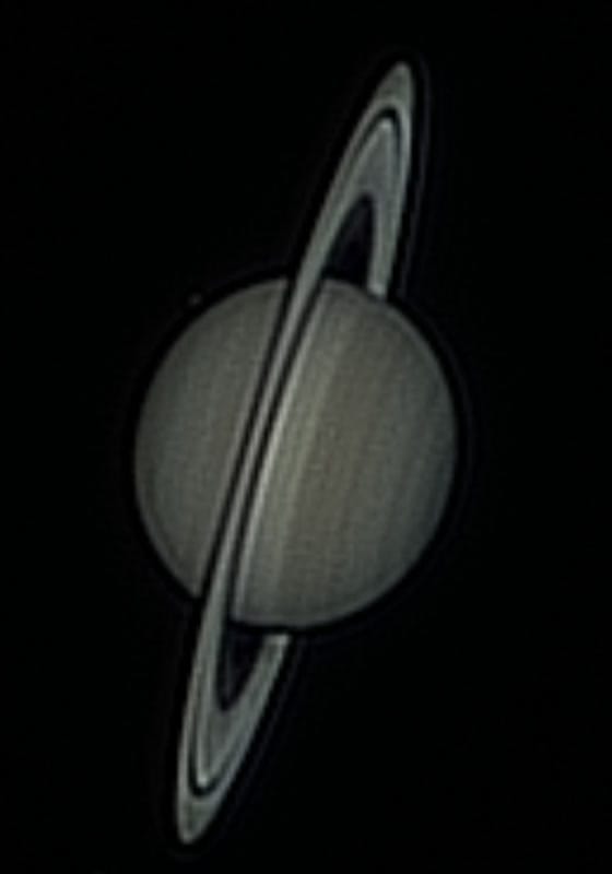 Saturn, way too far: Layer 1 at 4.96. A black ring around the globe, doubled ring edges and grain across the disc. More contrast, less Saturn.