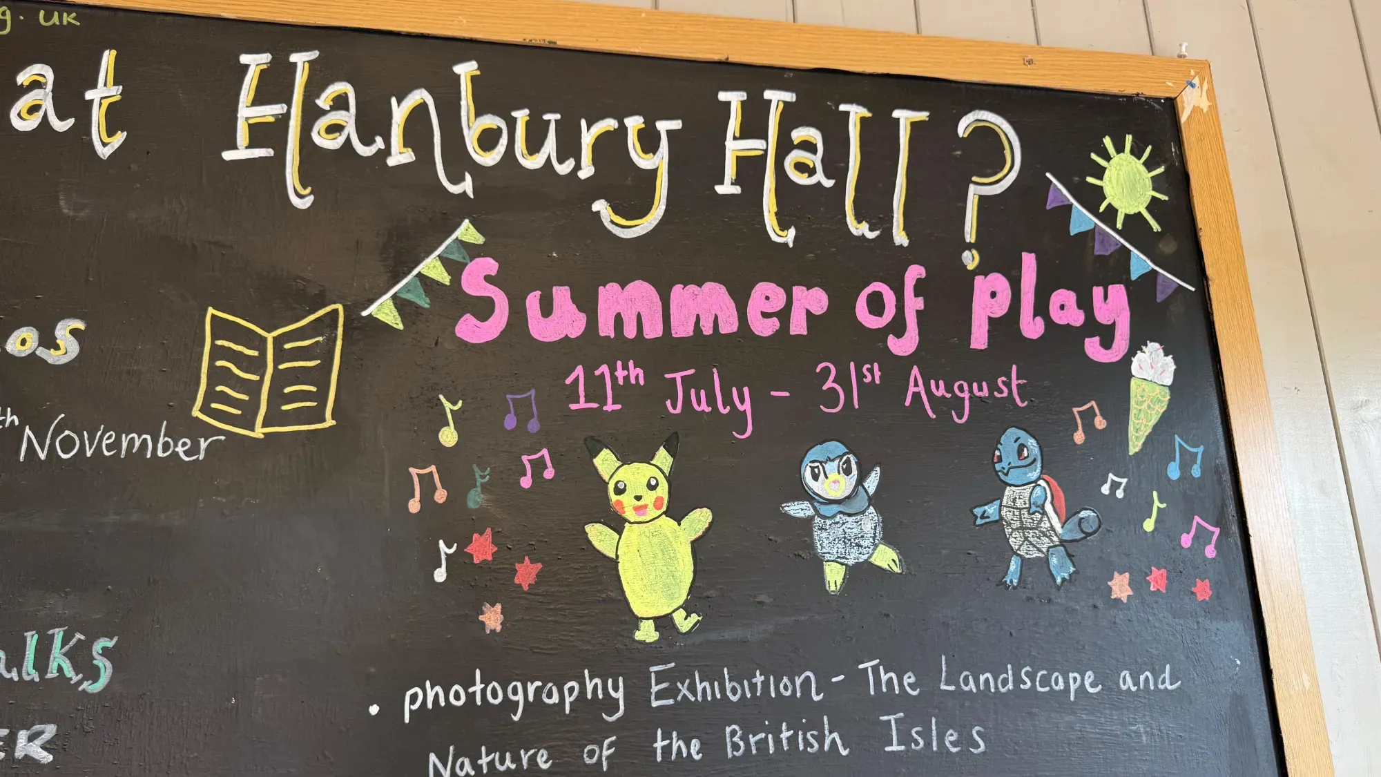 A chalk board drawing of Pikachu, Piplup and Squirtle underneath the text 'Hanbury Hall' and 'Summer of Play 11th July - 31st August'