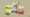 Smoliv, Astronaut Pikachu and Applin in front of a polygonal shape and textured background.