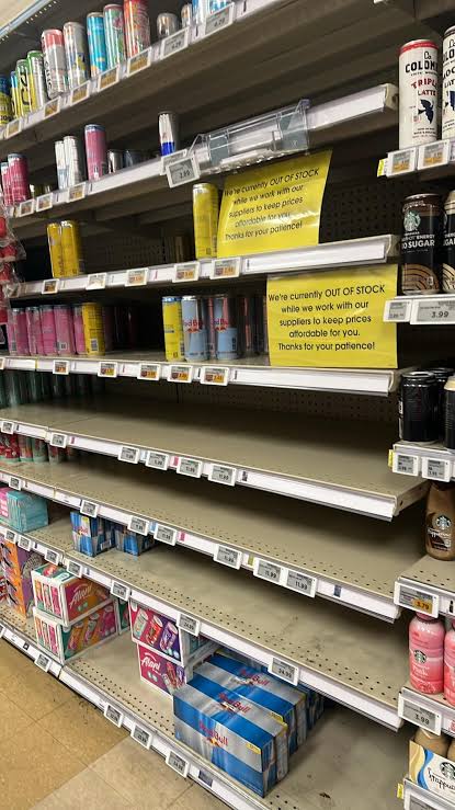 Empty Red Bull shelf at Kroger with out of stock sign citing supplier pricing