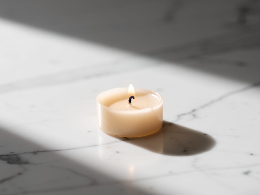 Low burning candle on white marble representing mental energy depletion