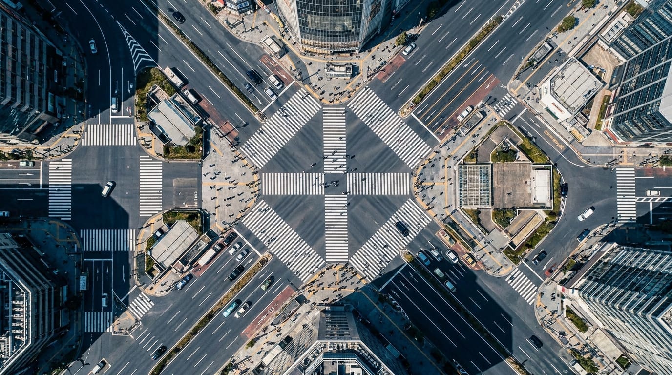 Busy city streets and crosswalks seen from above with rushing people